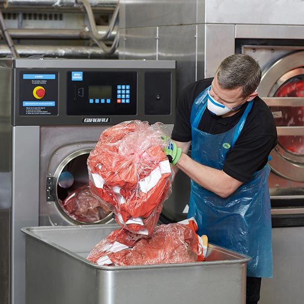 phs besafe employee prepare garments for a unique wash and launder